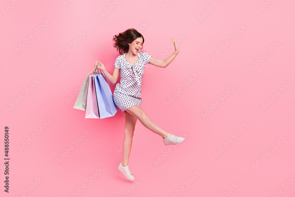 Full size photo of cheerful crazy girl jumping go shopping on black friday  isolated on pink color background Stock Photo | Adobe Stock