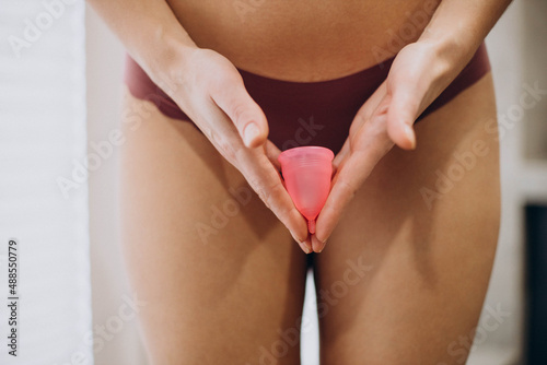 Woman holding menstrual cup in hands photo