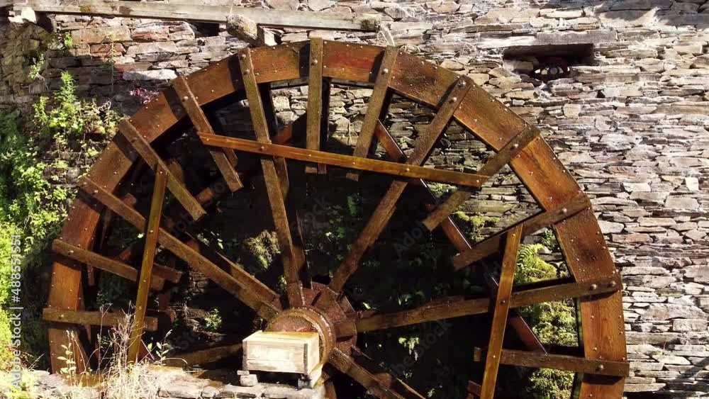 Big water wheel rotating fast, attached to an old stone house. Clean eco mill. Respect to the environment. Big water wheel rotating fast, attached to an old stone house. Clean eco mill. Respect to the environment.
