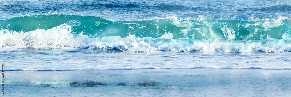 Fototapeta premium frontal breaking water wave border, fresh wave on the sunny beach, power of nature, recreation on the beach, wave of the sea banner background