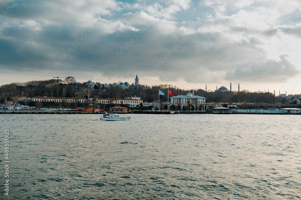 Bosphorus view, a small fishing boat passing through the Bosphorus, a blue and cloudy sky, freedom and shades of blue,Istanbul,Turkiye,01-30-2022