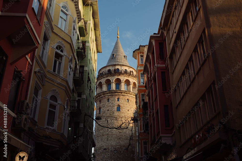 Galata tower, the castle with a historical Istanbul image, an ivy running through buildings, a unique view of the castle in a horizontal format taken from the narrow street.