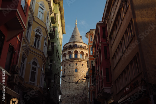 Galata tower, the castle with a historical Istanbul image, an ivy running through buildings, a unique view of the castle in a horizontal format taken from the narrow street.