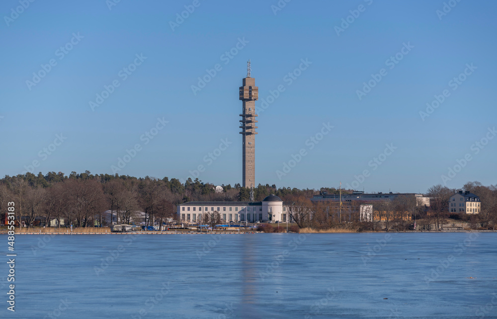 Panorama view, the frozen bay Djurgårdsviken with museums and the tele tower Kaknästornet a sunny winter day in Stockholm