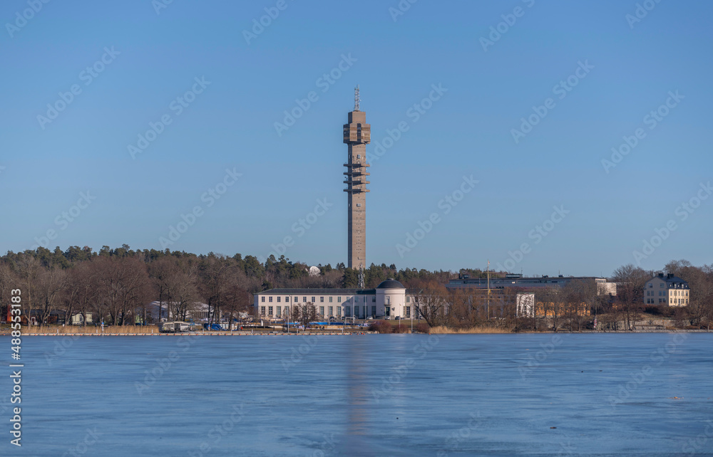Panorama view, the frozen bay Djurgårdsviken with museums and the tele tower Kaknästornet a sunny winter day in Stockholm Panorama view, the frozen bay Djurgårdsviken with museums and the tele tower Kaknästornet a sunny winter day in Stockholm