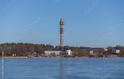 Panorama view, the frozen bay Djurgårdsviken with museums and the tele tower Kaknästornet a sunny winter day in Stockholm