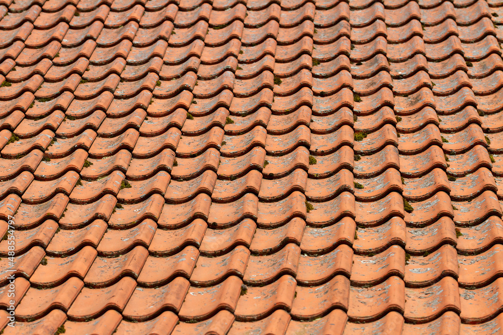 View of the quality tile roof of the old house. View of the quality tile roof of the old house.