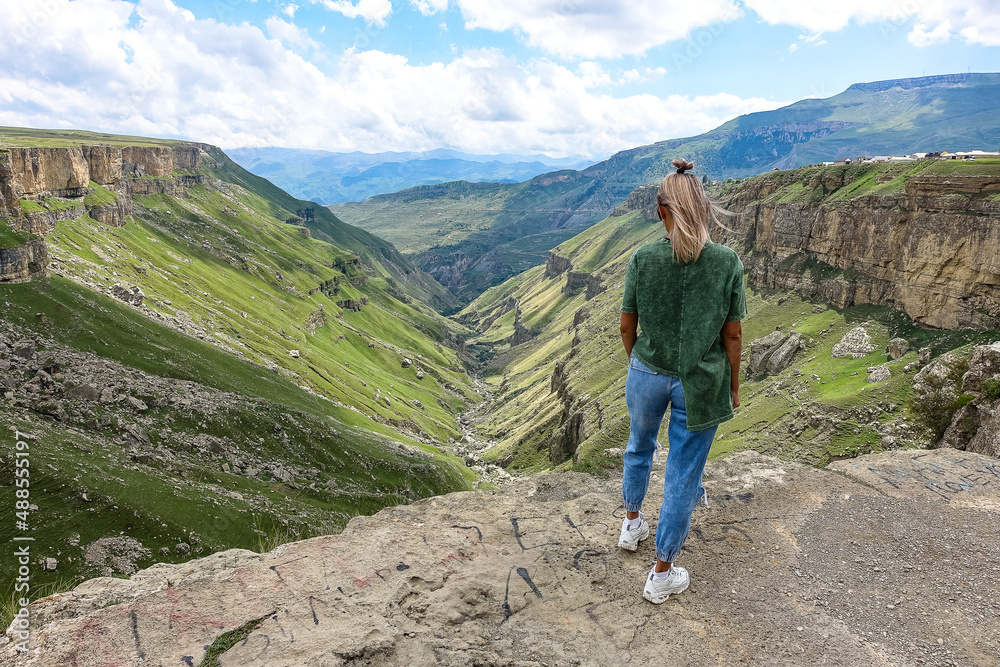Fototapeta premium A girl on the background of the Khunzakh valley, Khunzakh waterfalls, Dagestan 2021