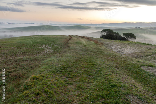 Scenic Tuscany landscape with rolling hills and valleys at sunrise