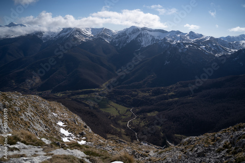 snow mountains over a green valley in picos de europa,national park, spain