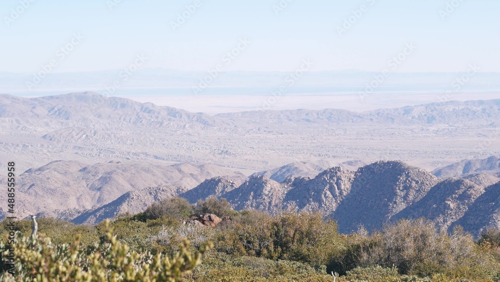Mountains and hills in desert valley, California wilderness, USA nature. Hiking or trekking in chaparral of mount Laguna. Scenic view of Salton sea from viewpoint. Arid dry badlands and flora plants.