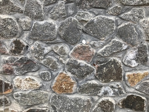 Stone wall. Vintage. Ancient stone laid out on the wall. For background.