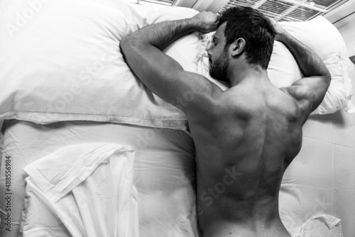Εκτύπωση καμβά Handsome naked muscular man with sleeping face down on bed with partial backside