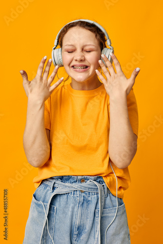 beautiful woman wearing headphones denim shorts close-up emotions Lifestyle unaltered