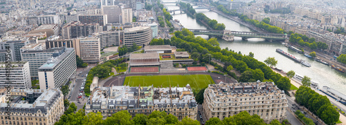 Aerial panoramic view of City skyline, football field and Seine river in Paris.