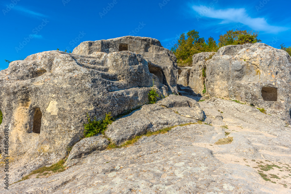 Ancient stone caves in a town-fortess Eski-Kermen high in a rocky mountains, Crimea.