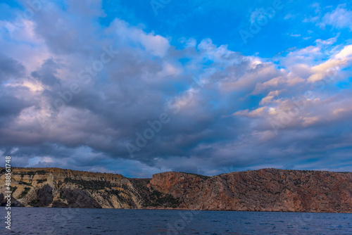 rocks of Cape Fiolent against the background of the evening sky with clouds