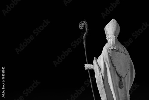 Catholic Church. Bishop with mitre and crosier, an old white marble statue on Lucca old walls, erected in the 17th century (Black and White with copy space) photo