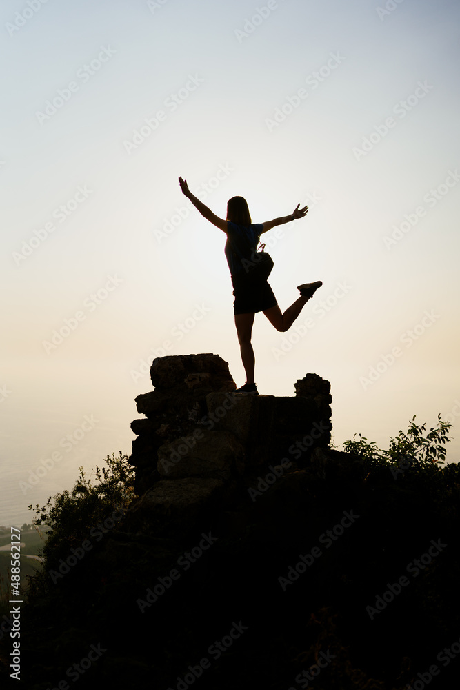 Woman successful hiking climbing silhouette in mountains, motivation and inspiration in beautiful sunset