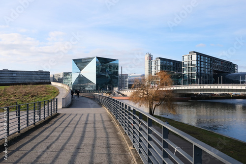 Berlin, Germany, February 12, 2022, view from the riverside promenade at the Spreebogenpark to the main station with Berlin Cube photo