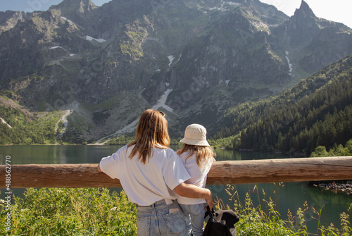 Mother with daughter near the Eye of the Sea lake (Morskie Oko) in Tatra mountain, Poland. Family, travel.