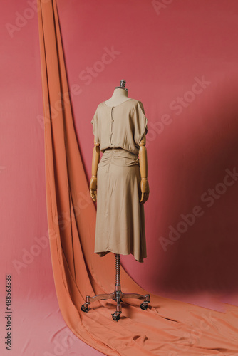 mannequin in a dress on a mannequin red pink background fashion still photography blouse skirt