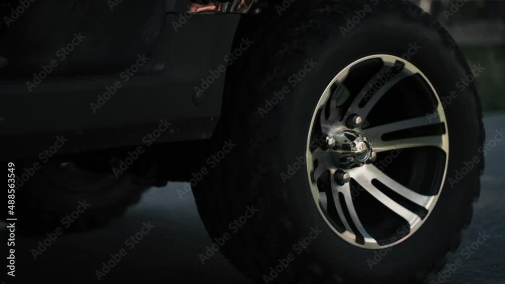 Close up of stylish silver rims of a golf cart driving
