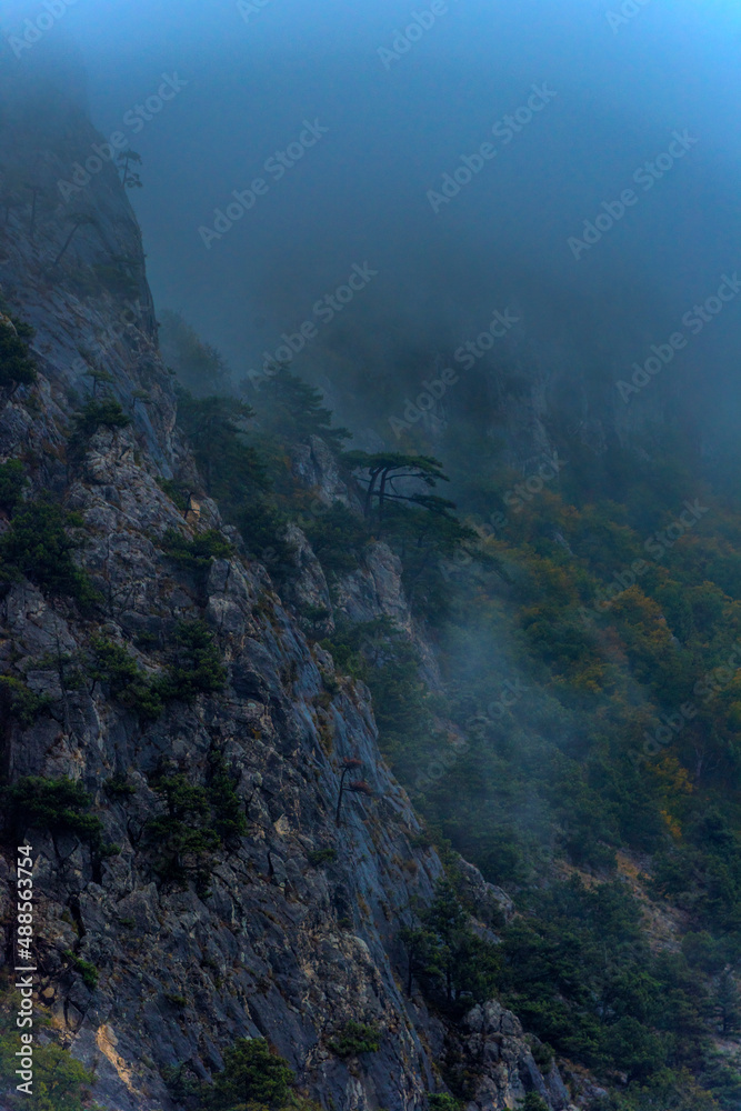 Stony slopes of mountain in dense fog. Stony slopes of mountain in dense fog.