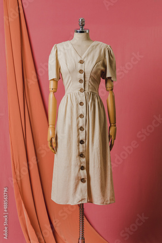 mannequin in a dress on a mannequin red pink background fashion still photography blouse skirt