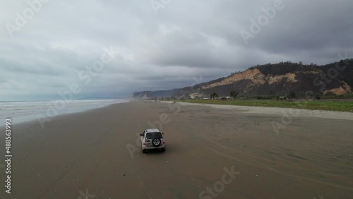Following a SUV with a drone on the beach in Ecuador filmed in 5k photo