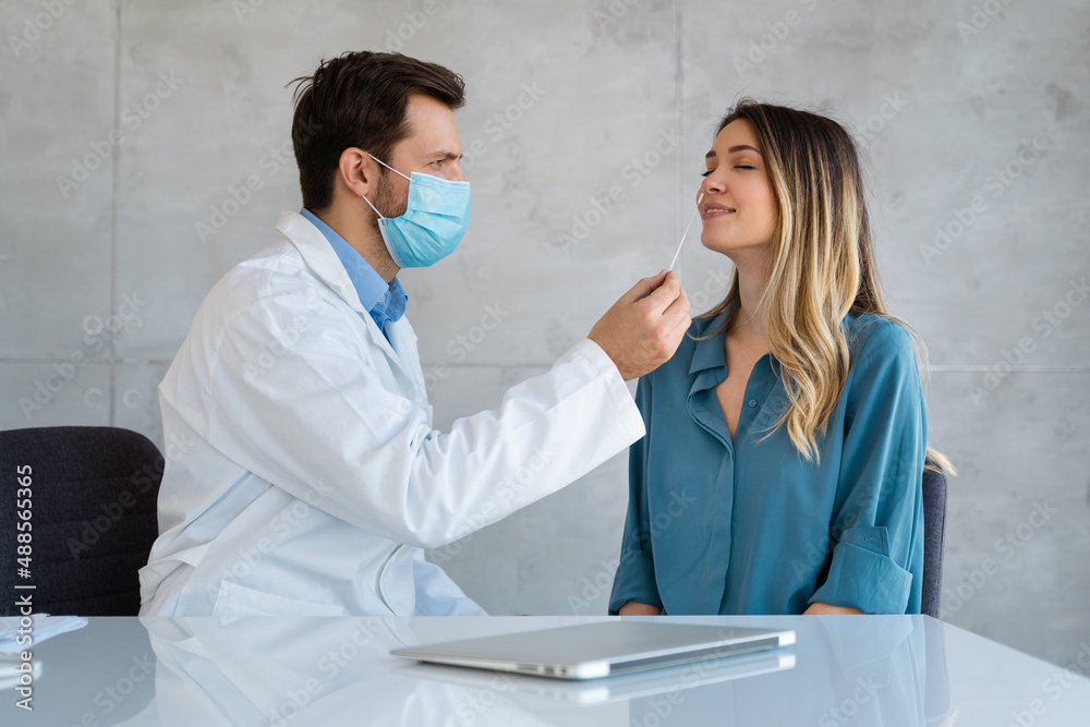 Medical nurse is taking a PCR Coronavirus sample in a clinic. Doctor uses respiratory swab test. Medical nurse is taking a PCR Coronavirus sample in a clinic. Doctor uses respiratory swab test.
