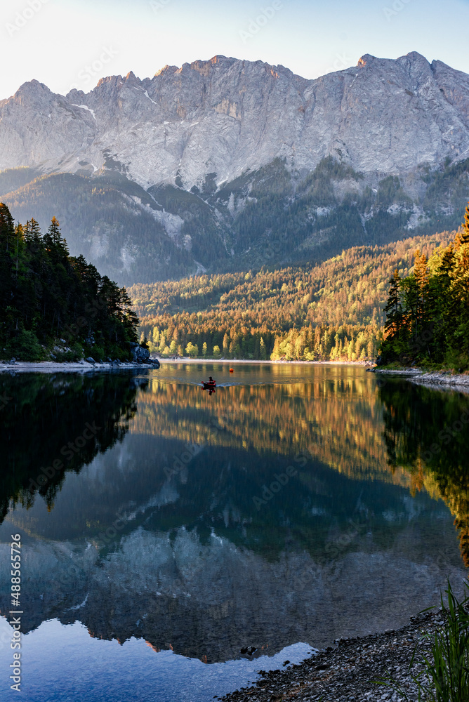 Impressive summer sunrise at Eibsee lake with Zugspitze mountain. Sunny outdoor scene in German Alps, Bavaria, Germany, Europe. Panorama Eibsee lake in the Alps. 
