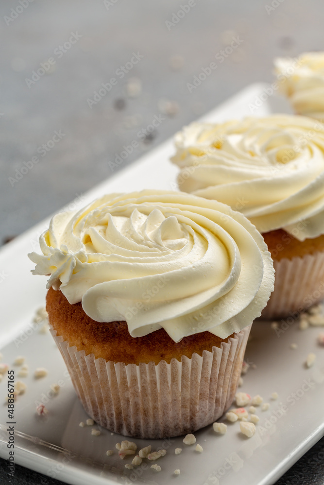 Cupcakes or muffins with cream. Holiday cake celebration, delicious dessert, close up Cupcakes or muffins with cream. Holiday cake celebration, delicious dessert, close up