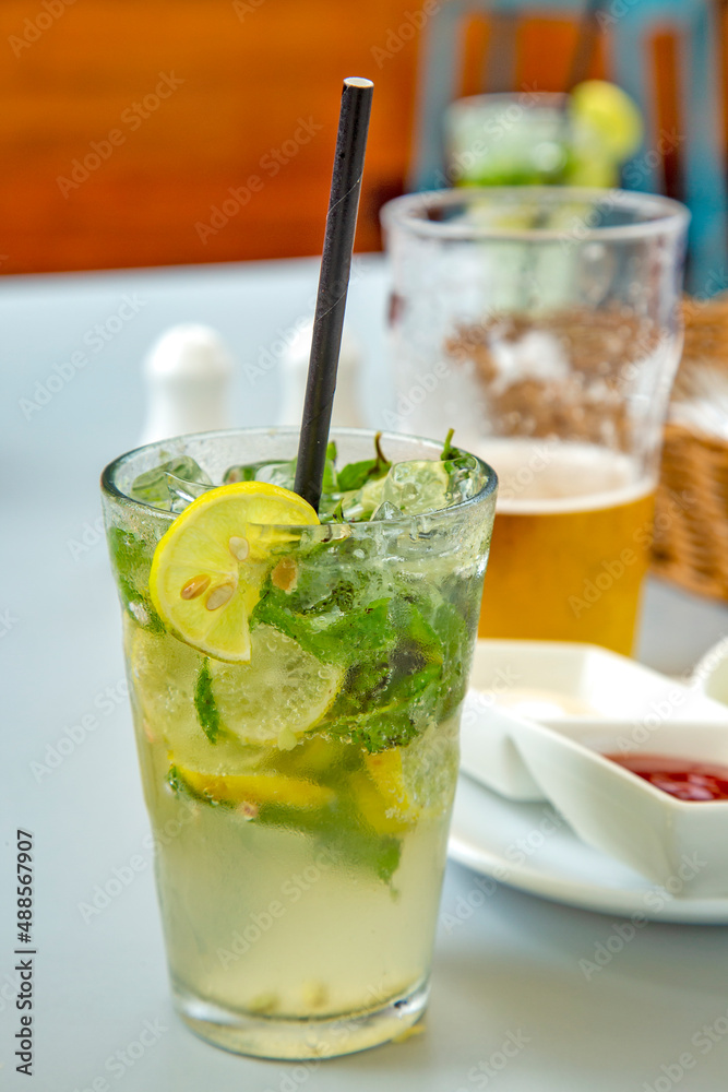 glass of mojito drink with mint and sliced lemon. glass of mojito drink with mint and sliced lemon.