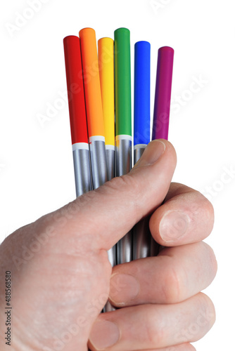 Obraz na płótnie Male hand holding six colored pencils in LGBT rainbow colors. Bright color pencils isolated on white background. Closeup w salonie