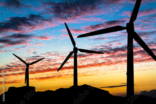 Wind turbines farm against the backdrop of a beautiful sky at sunset. Windmills at sunset.