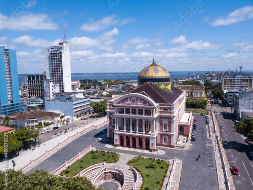 Beautiful drone aerial view of iconic Amazonas theater and city center houses, buildings and streets in sunny summer day in Amazon Rainforest. Rio Negro in the background. Manaus, Amazonas, Brazil. photo