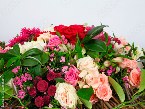 Flower arrangement with roses on light gray background