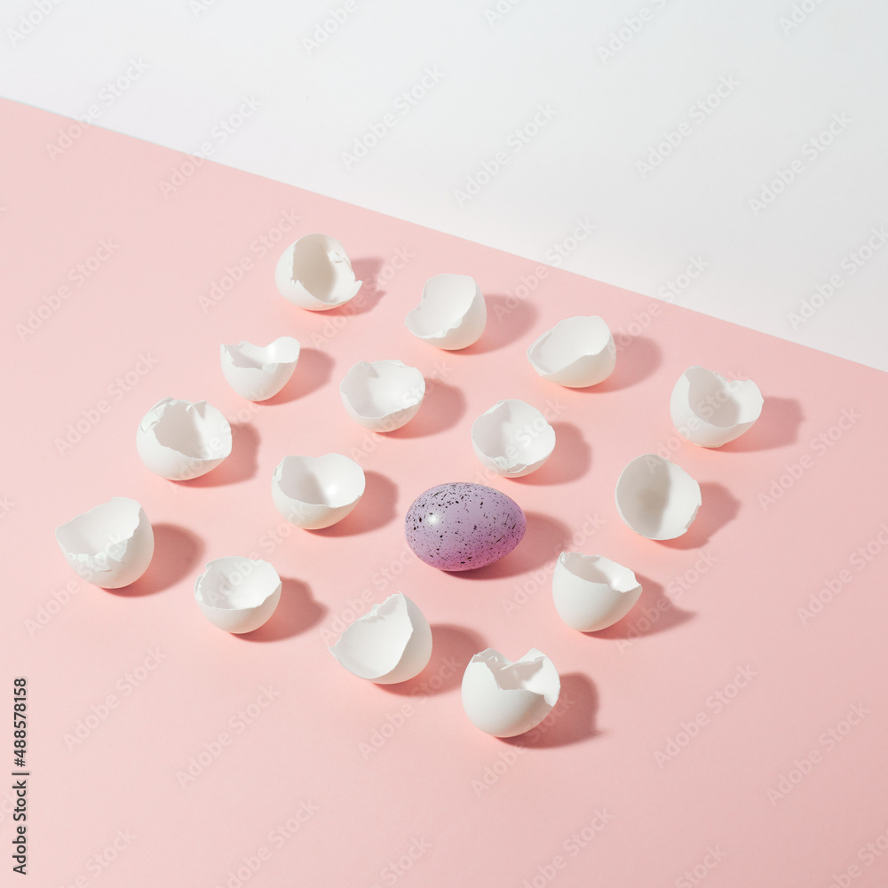 Creative composition made of cracked eggshell on pink and white background. Minimal Easter holiday concept. Creative composition made of cracked eggshell on pink and white background. Minimal Easter holiday concept.