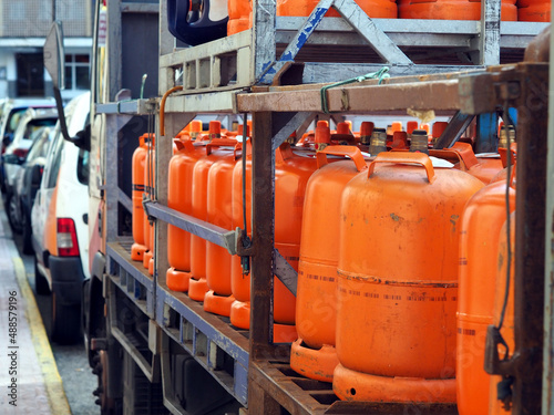 LPG cylinders. Orange bottles with butane.Truck delivered propane cylinders. Many gas tanks