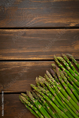 fresh green asparagus on wooden surface