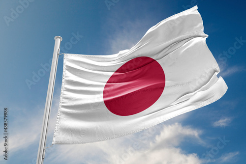 Japanese Flag is Waving Against Blue Sky