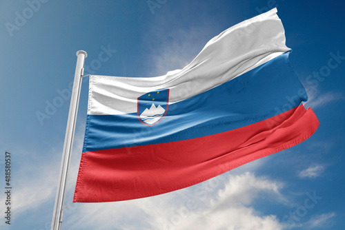 Slovenia Flag is Waving Against Blue Sky
