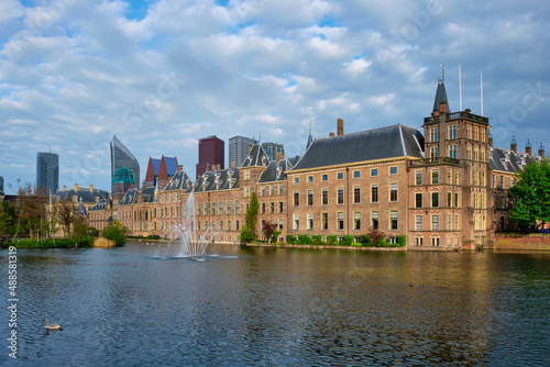 View of the Binnenhof House of Parliament and the Hofvijver lake with downtown skyscrapers in background. The Hague  Netherlands
