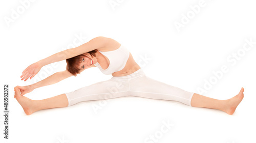 Canvas Print Full length portrait of a young beautiful gymnast with perfect figure stretching