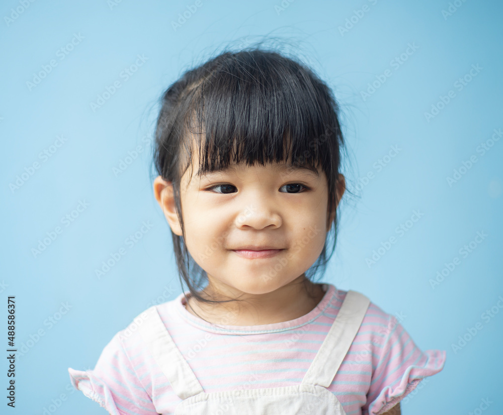 A headshot portrait of a cheerful baby Asian woman, a cute toddler little girl with adorable bangs hair, a child wearing a purple sweater smiling and don't looking to the camera. A headshot portrait of a cheerful baby Asian woman, a cute toddler little girl with adorable bangs hair, a child wearing a purple sweater smiling and don't looking to the camera.