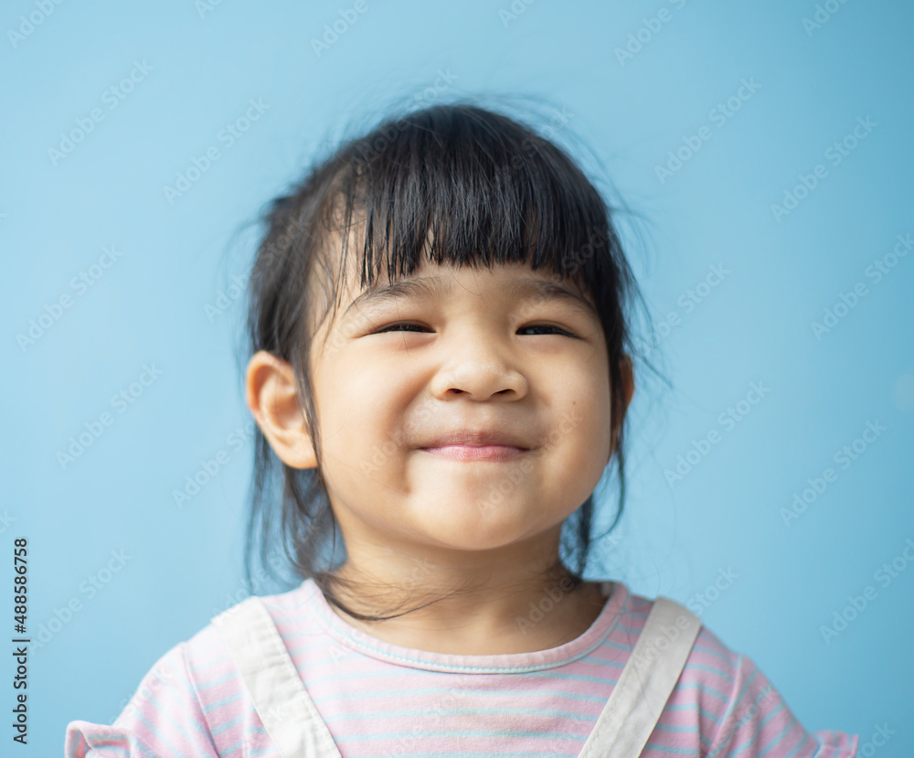 A headshot portrait of a cheerful baby Asian woman, a cute toddler little girl with adorable bangs hair, a child wearing a purple sweater smiling and don't looking to the camera. A headshot portrait of a cheerful baby Asian woman, a cute toddler little girl with adorable bangs hair, a child wearing a purple sweater smiling and don't looking to the camera.