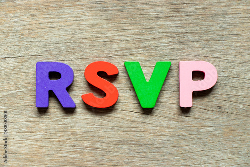 Color alphabet letter in word RSVP (Abbreviation of French word répondez s'il vous plaît) on wood background