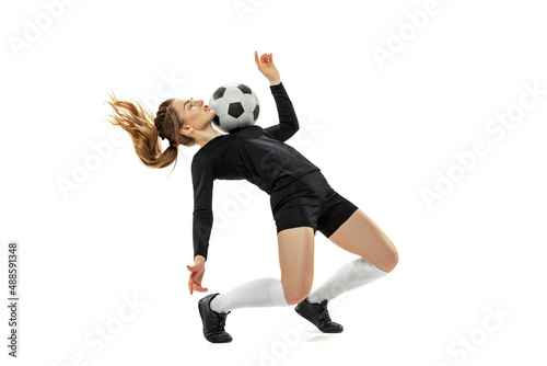 Striker. Professional female soccer  football player in action  motion isolated on white studio background. Sport  action  motion  fitness