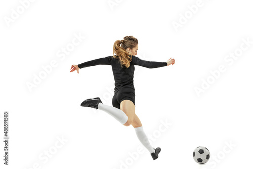 Striker. Professional female soccer, football player in action, motion isolated on white studio background. Sport, action, motion, fitness